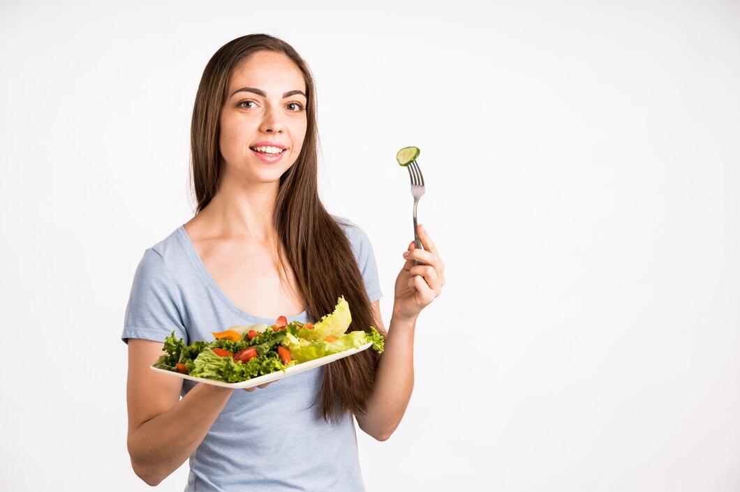 woman-holding-salad-looking-camera_23-2148256137