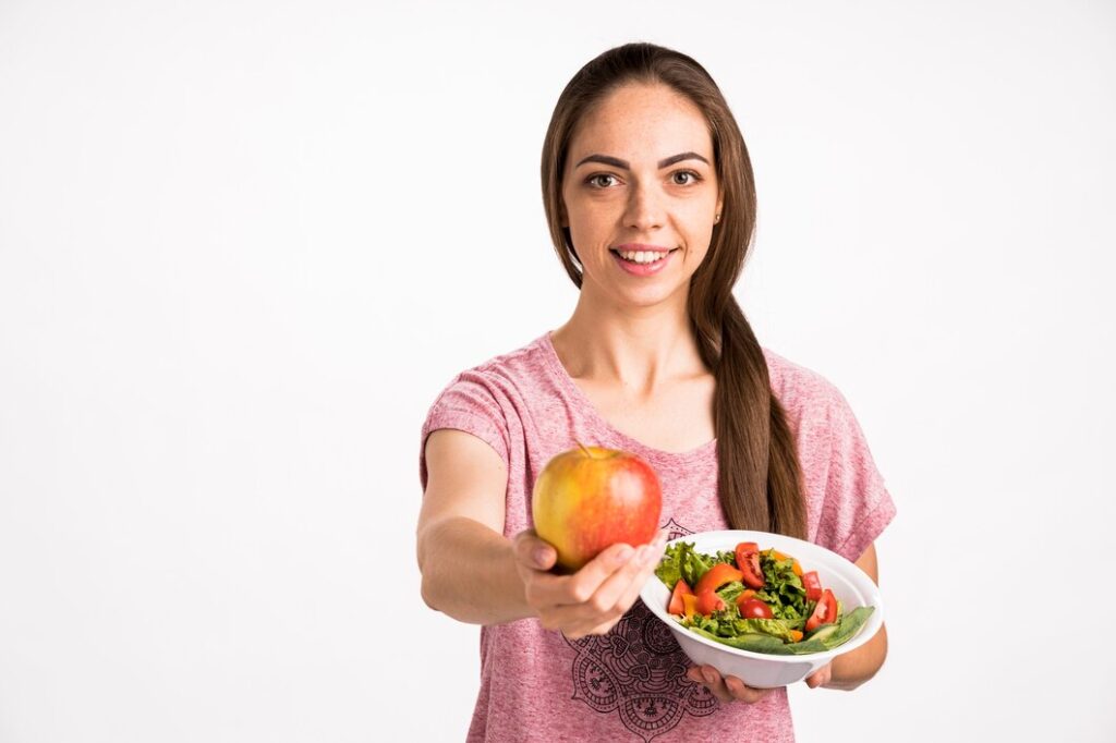 woman showing apple holding salad 23 2148256136